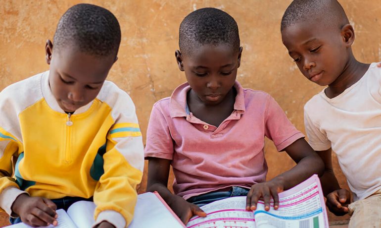 3 children reading books