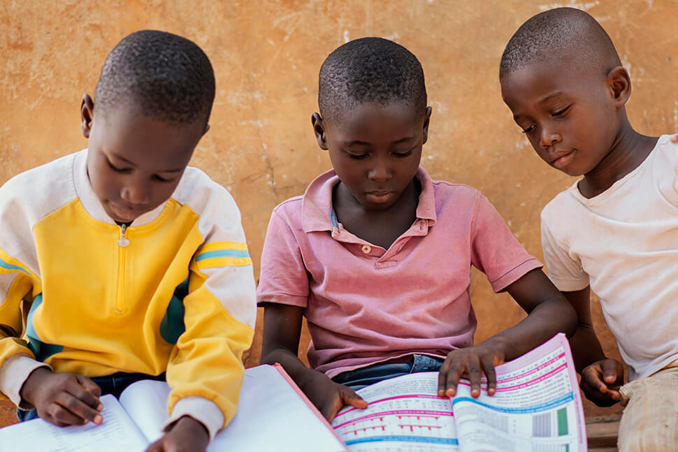 3 children reading books