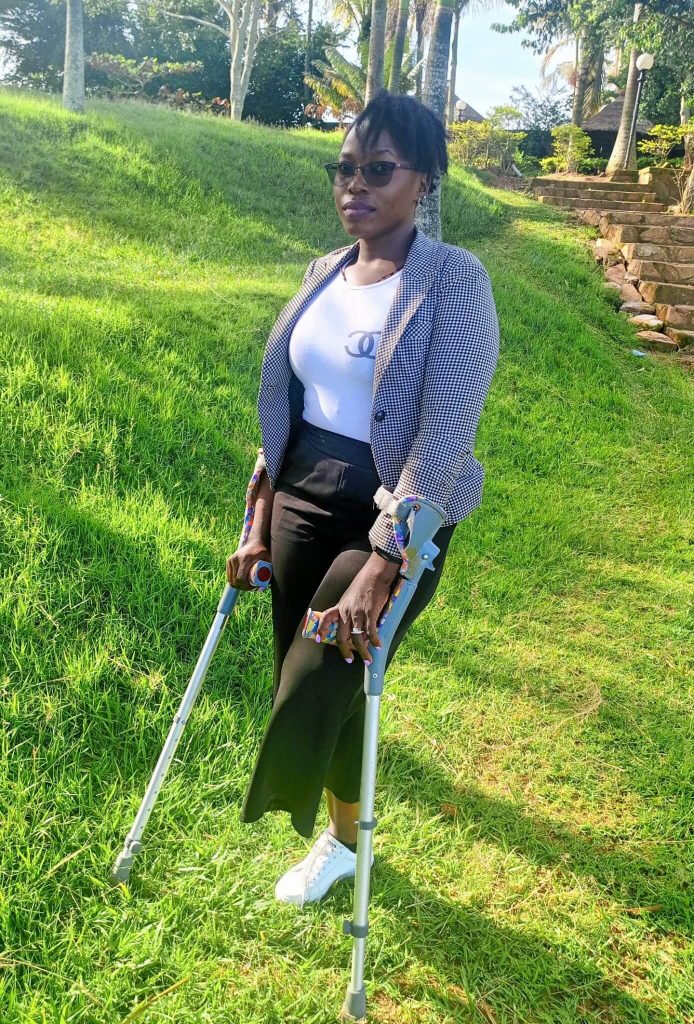 Photo of Catherine Nakanyiga on crutches.